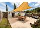 Inviting backyard with shade canopy, outdoor furniture, and well-maintained landscaping at 5527 Kelly N Dr, St Petersburg, FL 33703