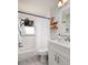 Bright bathroom with modern fixtures, white cabinets, and a shower-tub combo at 5527 Kelly N Dr, St Petersburg, FL 33703