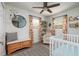 Bright Bedroom room with light walls, ceiling fan, and a crib at 5527 Kelly N Dr, St Petersburg, FL 33703