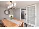 Dining room with a light wood table, stylish chandelier, and access to the kitchen with stainless refrigerator at 5527 Kelly N Dr, St Petersburg, FL 33703