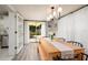 Dining room with table and chairs, sliding door, outdoor backyard view, and access to kitchen at 5527 Kelly N Dr, St Petersburg, FL 33703