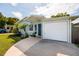 The exterior view captures a well-maintained house with an attached garage at 5527 Kelly N Dr, St Petersburg, FL 33703