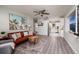 Open-concept living room with modern furnishings and view to kitchen at 5527 Kelly N Dr, St Petersburg, FL 33703