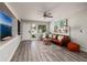 Inviting living room with gray floors, comfortable seating, and a ceiling fan for added comfort at 5527 Kelly N Dr, St Petersburg, FL 33703