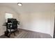 Bright shed interior, furnished as an office space with a desk, chair, computer, and rug on the laminate flooring at 5527 Kelly N Dr, St Petersburg, FL 33703