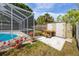 A pool is next to an outdoor storage shed and picnic table, blending functionality and relaxation at 5717 60Th N Way, St Petersburg, FL 33709