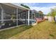A screened-in pool is adjacent to a deck, complemented by flower beds and an outdoor storage shed at 5717 60Th N Way, St Petersburg, FL 33709