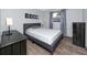 Cozy bedroom with a gray bed frame, neutral walls, and natural light at 5717 60Th N Way, St Petersburg, FL 33709