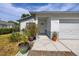 Charming home entrance is accentuated by beautiful potted plants at 5717 60Th N Way, St Petersburg, FL 33709