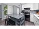 Bright kitchen featuring a central island with stool seating and modern appliances at 5717 60Th N Way, St Petersburg, FL 33709