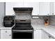 Modern kitchen features stainless steel appliances, white cabinets, and stylish backsplash at 5717 60Th N Way, St Petersburg, FL 33709