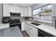 Modern kitchen showcasing white cabinets, countertops, stainless steel appliances, and ample natural light at 5717 60Th N Way, St Petersburg, FL 33709