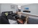 Comfortable living room features a dark leather sectional and mounted flat screen TV at 5717 60Th N Way, St Petersburg, FL 33709