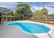 Enjoy this kidney-shaped pool inside a screened lanai, providing an ideal backyard retreat at 5717 60Th N Way, St Petersburg, FL 33709
