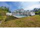 The backyard features a screened-in pool, offering a private outdoor retreat with lush landscaping at 5717 60Th N Way, St Petersburg, FL 33709