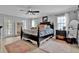 Bright bedroom features plush carpets, a ceiling fan, and plenty of natural light at 5907 S Elkins Ave, Tampa, FL 33611