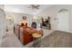 Comfortable living room with fireplace, large windows, vaulted ceilings, and a ceiling fan at 6001 Laketree Ln # B, Temple Terrace, FL 33617