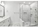 Bright bathroom with a marble-walled walk-in shower and a sleek single sink vanity at 6605 N Nebraska Ave # 25, Tampa, FL 33604