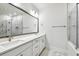 Modern bathroom boasting double sinks, a large mirror, and marble shower at 6605 N Nebraska Ave # 25, Tampa, FL 33604