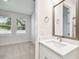 Bright bathroom with white vanity, sink and views into adjacent bedroom at 6605 N Nebraska Ave # 25, Tampa, FL 33604