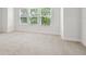 Large bedroom features carpeted floors, neutral walls, and lots of natural light from large windows at 6605 N Nebraska Ave # 25, Tampa, FL 33604