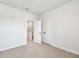 Neutral bedroom with neutral carpet, featuring closet and doorway at 6605 N Nebraska Ave # 25, Tampa, FL 33604