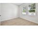 Bright bedroom featuring neutral carpet and dual windows, offering ample natural light at 6605 N Nebraska Ave # 25, Tampa, FL 33604