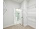Bright walk-in closet with shelving, carpet, and bathroom access at 6605 N Nebraska Ave # 25, Tampa, FL 33604