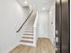 Inviting entryway featuring a staircase, a light wood floor, and a modern design at 6605 N Nebraska Ave # 25, Tampa, FL 33604