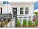 Home featuring a well-maintained exterior, a black front door, and neat landscaping at 6605 N Nebraska Ave # 25, Tampa, FL 33604