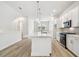Bright kitchen features white cabinets, stainless steel appliances, and a large center island at 6605 N Nebraska Ave # 25, Tampa, FL 33604