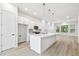Open-concept kitchen with sleek island, white cabinetry, and ample space for dining and living at 6605 N Nebraska Ave # 25, Tampa, FL 33604