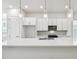 Bright, open kitchen features white cabinets, stainless steel appliances, and quartz countertops at 6605 N Nebraska Ave # 25, Tampa, FL 33604