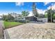 Spacious backyard with a screened lanai, large patio, and partial fencing at 6704 N Branch Ave, Tampa, FL 33604