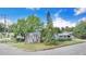 Charming single-story home featuring a well-maintained lawn, mature trees, and inviting curb appeal at 6704 N Branch Ave, Tampa, FL 33604