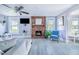 Cozy living room featuring a brick fireplace, comfortable seating, and abundant natural light at 6704 N Branch Ave, Tampa, FL 33604