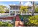 Stunning outdoor space with a pool, outdoor kitchen, lush yard, and a second story deck at 6805 Arroyo Dr, New Port Richey, FL 34652