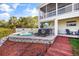 Backyard paradise features a spa, outdoor kitchen, and wooden walkway to the house at 6805 Arroyo Dr, New Port Richey, FL 34652