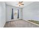 Bedroom with neutral carpet, ceiling fan, and large window at 6805 Arroyo Dr, New Port Richey, FL 34652
