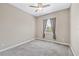 Bedroom with neutral carpet, ceiling fan, and natural light at 6805 Arroyo Dr, New Port Richey, FL 34652