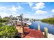 Boat lift and boat on calm water near lush greenery in sunny weather at 6805 Arroyo Dr, New Port Richey, FL 34652