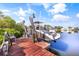 Boat secured on a boat lift with a tranquil waterway surrounded by lush mangroves at 6805 Arroyo Dr, New Port Richey, FL 34652