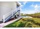 Exterior of the home featuring a pool and a staircase leading to the second story deck at 6805 Arroyo Dr, New Port Richey, FL 34652