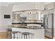 Eat-in kitchen with stainless appliances, granite counters, and bar seating at 6805 Arroyo Dr, New Port Richey, FL 34652