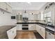 Well-lit kitchen features stainless appliances, granite counters, and white cabinetry at 6805 Arroyo Dr, New Port Richey, FL 34652