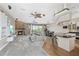Expansive living room with a stone fireplace, plush seating, and an open layout to the kitchen and dining areas at 6805 Arroyo Dr, New Port Richey, FL 34652