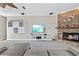 Comfortable living room with a fireplace, built-in shelving, and a large television at 6805 Arroyo Dr, New Port Richey, FL 34652