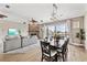 Living and dining area features hardwood floors, fireplace, and water view balcony at 6805 Arroyo Dr, New Port Richey, FL 34652