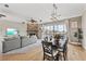 Open concept living and dining area with hardwood floors, fireplace, and balcony at 6805 Arroyo Dr, New Port Richey, FL 34652