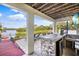 Outdoor bar with sink and mini fridge overlooking the dock and canal at 6805 Arroyo Dr, New Port Richey, FL 34652